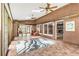 Bright sunroom with brick walls, tile floors, ceiling fans, and large windows offering plenty of natural light at 11270 Stroup Road, Roswell, GA 30075
