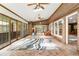 Bright sunroom with brick walls, tile floors, ceiling fans and large windows offering plenty of natural light at 11270 Stroup Road, Roswell, GA 30075