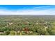 Aerial view of lush neighborhood with large trees, showing houses, yards, and streets below at 1637 Willow Way, Woodstock, GA 30188