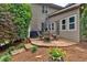 Charming outdoor patio area with stone tiling, a barbecue grill and a table with chairs at 1637 Willow Way, Woodstock, GA 30188