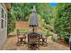 Cozy patio area with stone tiling features a seating area perfect for outdoor dining and relaxation at 1637 Willow Way, Woodstock, GA 30188