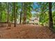 Picturesque backyard featuring a swing and an outdoor seating area surrounded by lush trees at 1637 Willow Way, Woodstock, GA 30188