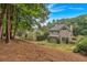 View of the backyard featuring a two-story home, landscaping, trees, and a well-maintained lawn at 1637 Willow Way, Woodstock, GA 30188