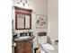 Powder room showcasing ornate vanity, granite countertop, and decorative mirror at 1637 Willow Way, Woodstock, GA 30188