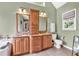 Bathroom with dual vanities, wood cabinets, granite countertops and tiled floors at 1637 Willow Way, Woodstock, GA 30188