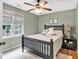 Inviting bedroom with hardwood floors, large windows, and a ceiling fan at 1637 Willow Way, Woodstock, GA 30188