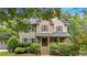 Inviting two-story home with covered porch, stairs and well-maintained landscaping at 1637 Willow Way, Woodstock, GA 30188