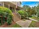 Covered front porch with stairs and decorative landscaping create a warm welcome at 1637 Willow Way, Woodstock, GA 30188