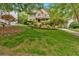 Beautiful two-story home with a well-manicured front lawn and lush landscaping at 1637 Willow Way, Woodstock, GA 30188