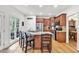 Gorgeous kitchen with stainless steel appliances, granite countertops, wood cabinets, and island with seating at 1637 Willow Way, Woodstock, GA 30188