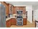 Well-equipped kitchen features stainless steel appliances, granite countertops, and beautiful wood cabinets at 1637 Willow Way, Woodstock, GA 30188