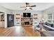 Comfortable living room with stone fireplace, ceiling fan, and hardwood floors at 1637 Willow Way, Woodstock, GA 30188
