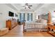 Spacious main bedroom with tray ceilings, hardwood floors, and a ceiling fan at 1637 Willow Way, Woodstock, GA 30188