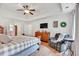 Main bedroom with tray ceiling, decor, TV, dresser, lounge chair, and wood floors at 1637 Willow Way, Woodstock, GA 30188