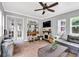 Cozy sunroom with tiled floors, comfortable sofa, and plenty of natural light at 1637 Willow Way, Woodstock, GA 30188