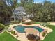 A captivating aerial view displays a large in-ground pool, patio, deck, and the house, all surrounded by lush landscaping at 2390 Sassafrass Ln, Powder Springs, GA 30127