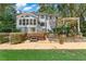 The home's outdoor space features a relaxing hot tub, a screened-in porch, and a beautifully landscaped patio area at 2390 Sassafrass Ln, Powder Springs, GA 30127
