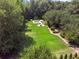 Enjoy the expansive backyard with lush lawn, mature trees, and a swimming pool area perfect for summer fun at 2390 Sassafrass Ln, Powder Springs, GA 30127