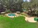 This huge backyard features a pool, hot tub, fire pit, and plenty of green space for entertaining and recreation at 2390 Sassafrass Ln, Powder Springs, GA 30127