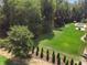 The large, private backyard boasts mature trees and landscaping with a pool area perfect for outdoor living and entertaining at 2390 Sassafrass Ln, Powder Springs, GA 30127