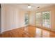 Bright bedroom with hardwood floors, ceiling fan, and sliding glass doors leading to a balcony at 2390 Sassafrass Ln, Powder Springs, GA 30127