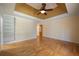 Bedroom featuring hardwood floors, built-in shelving, a trey ceiling, and neutral colors at 2390 Sassafrass Ln, Powder Springs, GA 30127