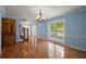Light filled dining room with hardwood floors, light blue walls with white wainscoting at 2390 Sassafrass Ln, Powder Springs, GA 30127