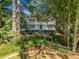 Charming two-story home featuring a welcoming facade with double balconies and a well-manicured front yard at 2390 Sassafrass Ln, Powder Springs, GA 30127