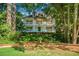 Stunning two-story home boasts double porches, well-manicured landscaping, and classic architectural details at 2390 Sassafrass Ln, Powder Springs, GA 30127