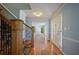 Foyer with wood floors, wooden staircase with carpet runner, and neutral walls at 2390 Sassafrass Ln, Powder Springs, GA 30127