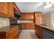 Kitchen featuring wood cabinets, granite countertops, stainless steel appliances, and tile backsplash at 2390 Sassafrass Ln, Powder Springs, GA 30127