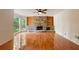 Open-concept living room with a stone fireplace, built-in shelving, and large windows at 2390 Sassafrass Ln, Powder Springs, GA 30127