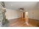 Spacious living room featuring hardwood floors and a stone fireplace with a ceiling fan at 2390 Sassafrass Ln, Powder Springs, GA 30127