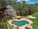 Aerial view of the private backyard pool and hot tub, surrounded by patio furniture and green landscaping at 2390 Sassafrass Ln, Powder Springs, GA 30127