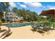 Beautiful backyard offers an inviting pool area with ample seating, dining space, and landscaped surroundings at 2390 Sassafrass Ln, Powder Springs, GA 30127