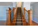Carpeted staircase with wooden banister and metal spindles at 2390 Sassafrass Ln, Powder Springs, GA 30127