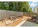 Landscaped backyard featuring a patio, stepped planter, and wooden fence, ideal for outdoor living at 3255 Clear View Dr, Snellville, GA 30078