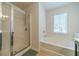 Bathroom featuring a separate glass shower, a soaking tub, and a window for natural light at 3255 Clear View Dr, Snellville, GA 30078