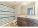 Bathroom with shower-tub combination, vanity with a modern countertop and dark cabinets at 3255 Clear View Dr, Snellville, GA 30078