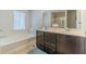 Bathroom with a double vanity, a soaking tub beneath a window, and tile flooring at 3255 Clear View Dr, Snellville, GA 30078