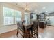 Dining area with stylish light fixture, hardwood floors, a bright window and views of the kitchen at 3255 Clear View Dr, Snellville, GA 30078