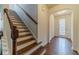 Inviting entryway featuring hardwood floors, a staircase with wood railings and a view of the front door at 3255 Clear View Dr, Snellville, GA 30078
