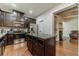 Gourmet kitchen with granite countertops, stainless steel appliances, dark cabinets, and an island at 3255 Clear View Dr, Snellville, GA 30078
