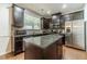 Modern kitchen with stainless steel appliances, dark wood cabinets, granite counters, and a functional center island at 3255 Clear View Dr, Snellville, GA 30078