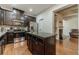 Stylish kitchen featuring dark wood cabinetry, stainless steel appliances, granite countertops and a kitchen island at 3255 Clear View Dr, Snellville, GA 30078