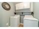 Well-equipped laundry room with white appliances, upper cabinets, and stylish wall accents at 3255 Clear View Dr, Snellville, GA 30078