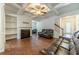 Inviting living room featuring a fireplace, built-in shelves, hardwood flooring, and a staircase at 3255 Clear View Dr, Snellville, GA 30078