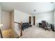 A cozy loft space features neutral carpet, a dark futon, and a functional desk area, ideal for a home office or study at 3255 Clear View Dr, Snellville, GA 30078