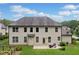 Spacious backyard features a patio, garden, and lush landscaping; perfect for entertaining at 4460 Hunters Walk Way, Cumming, GA 30028