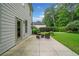 An outdoor patio with comfortable seating and a view of the private backyard at 4460 Hunters Walk Way, Cumming, GA 30028